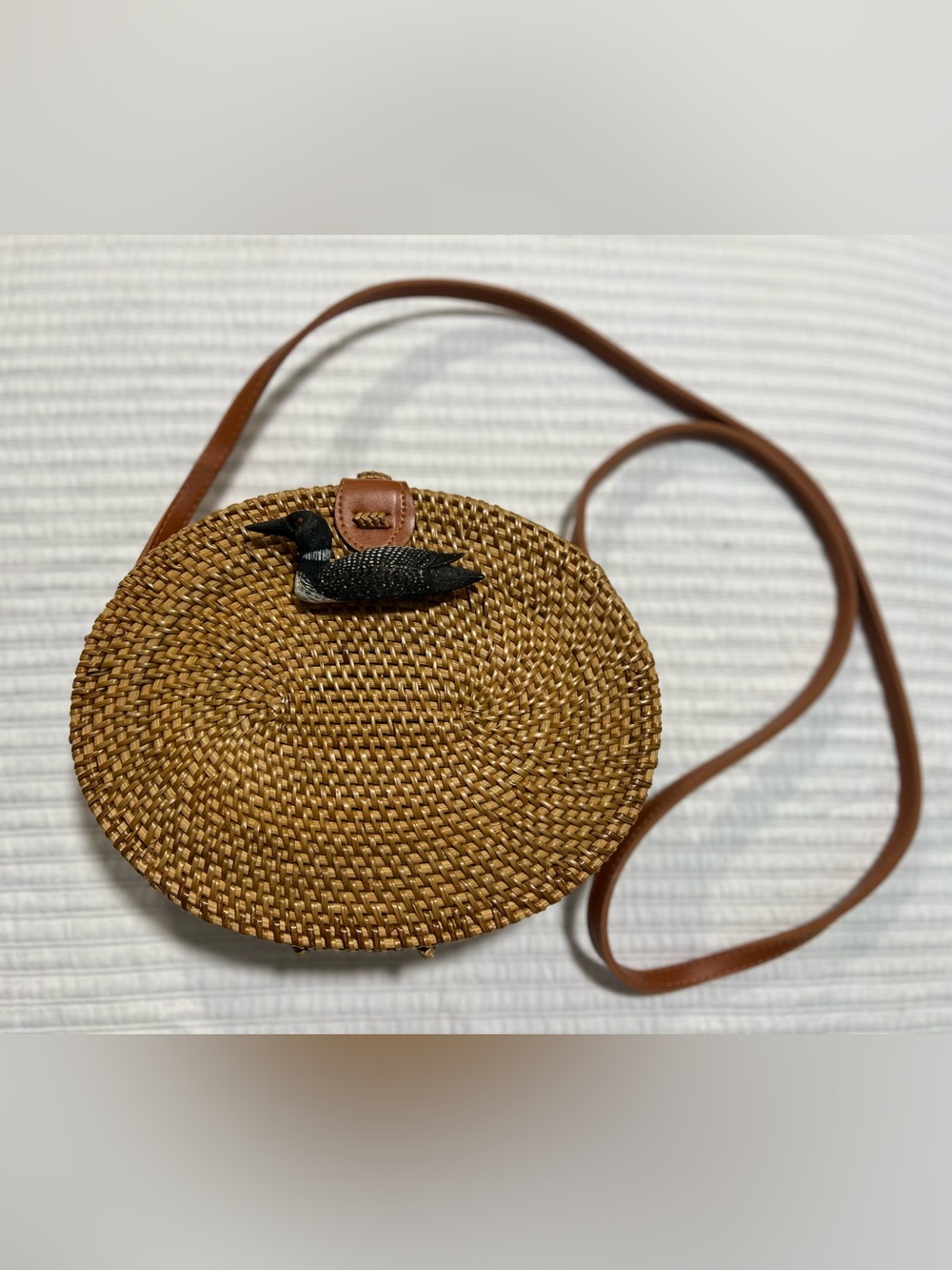 Woven Round Straw Crossbody with Leather Strap and Loon Accent